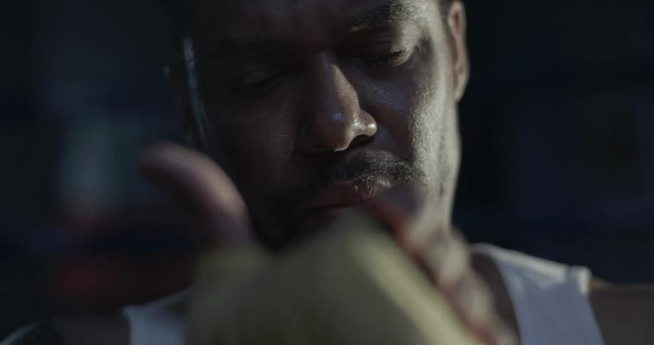 A man wraps his hand with athletic tape