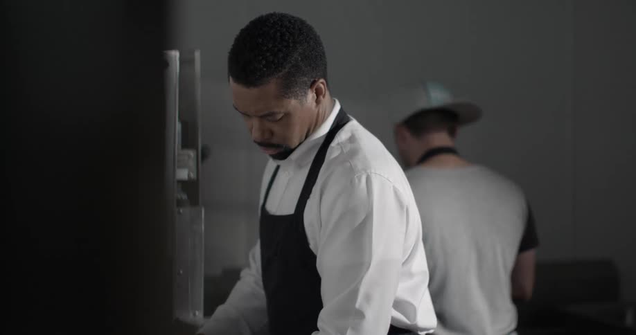 Two men work in a kitchen