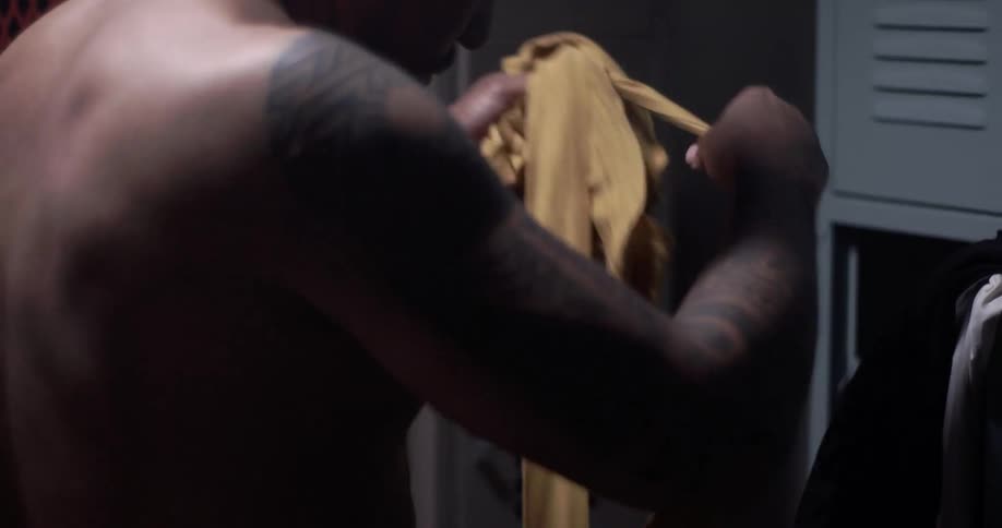 A man unravels a piece of yellow cloth
