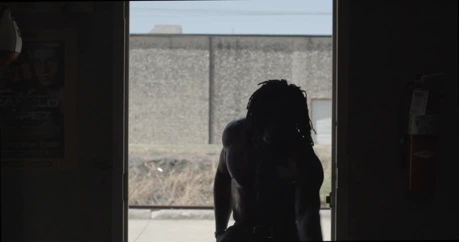 A man practicing dance moves in front of an open door