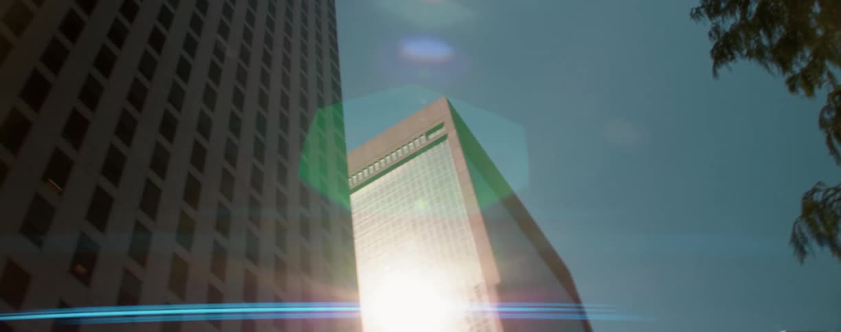 Tall buildings in the city reflects the sun on the windows