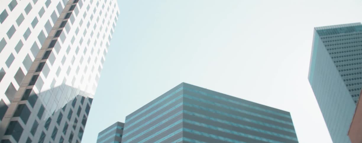 Building topped with spire and column supported dome occupies downtown