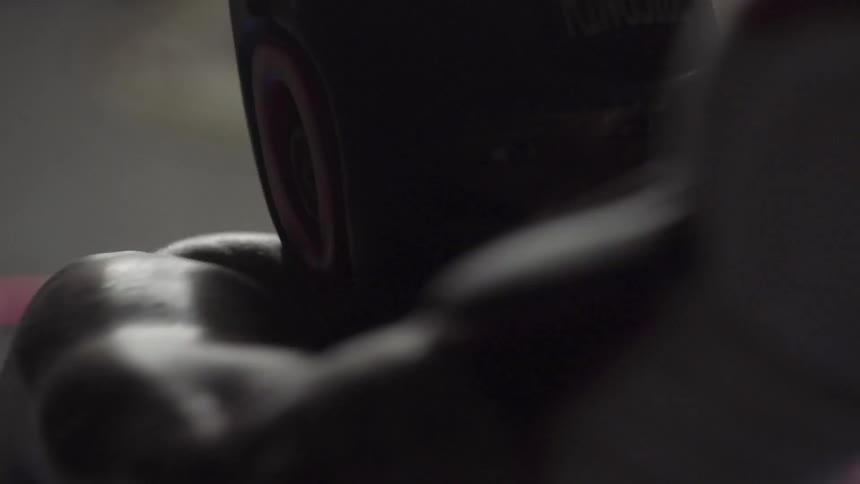 A boxer punches and spars in a boxing ring