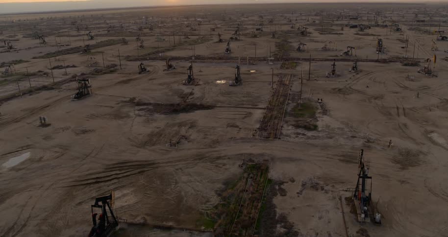 Oil rigs scattered across a dirt field