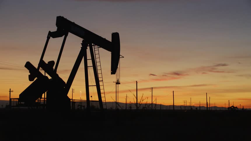 A pump jack with the sky in the background