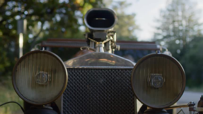A vintage car sitting on a street