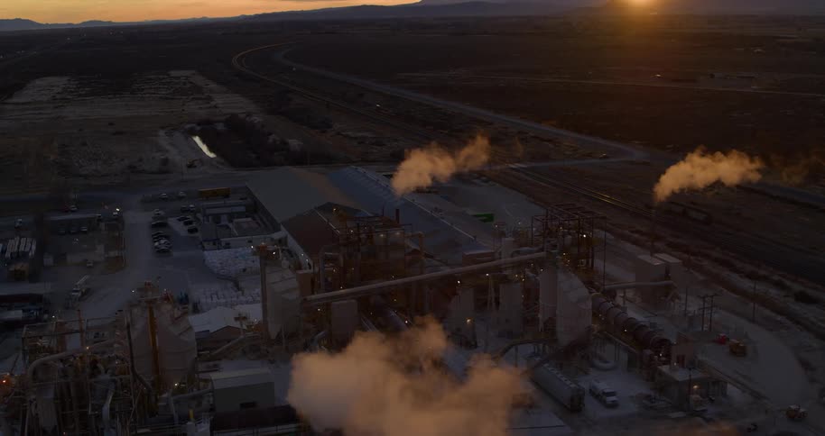 Smoke floats up from the factories at dusk