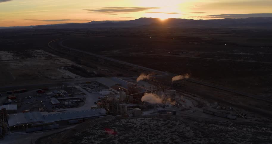 A refinery with the desert and the sky in the background