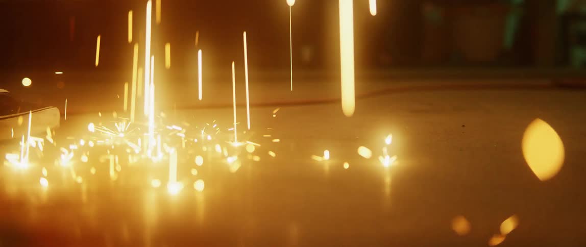 Sparks fly as a person works in a factory