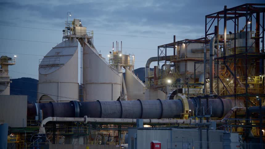 A refinery lit up as evening approaches