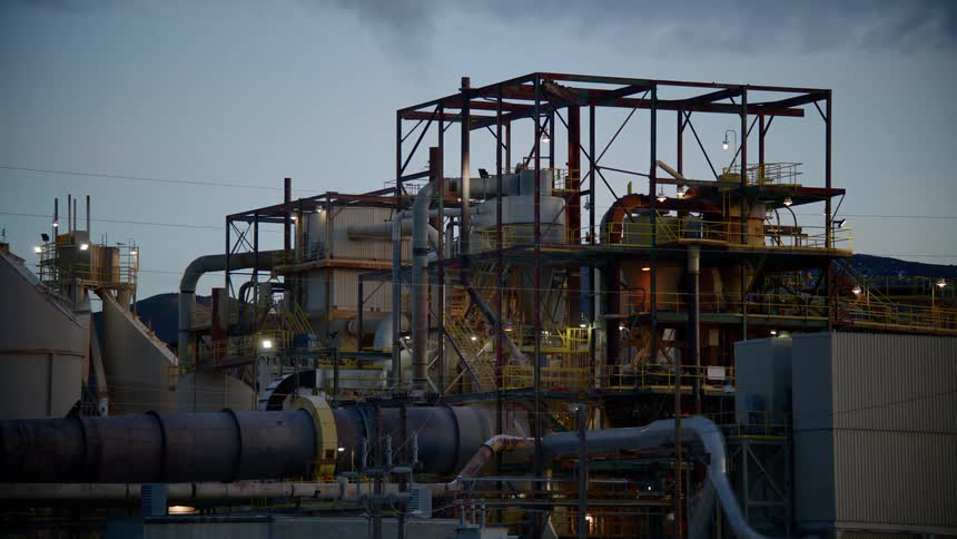 The outside of a refinery in the evening