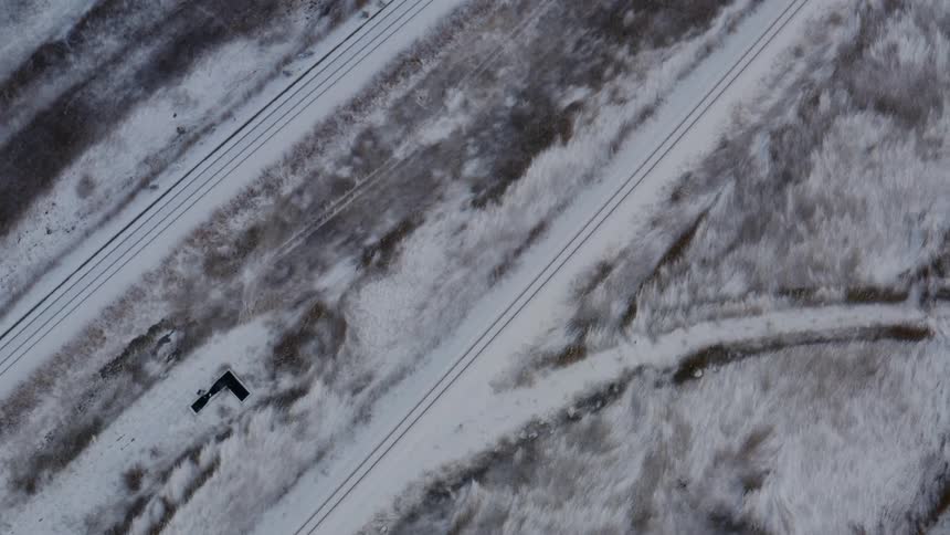Tire tracks run over a snow covered highway