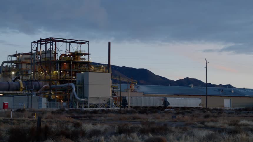The plant is lit up at sunset