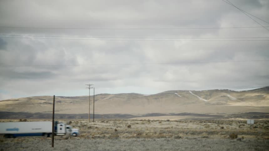 Trucks are driving in a rural area
