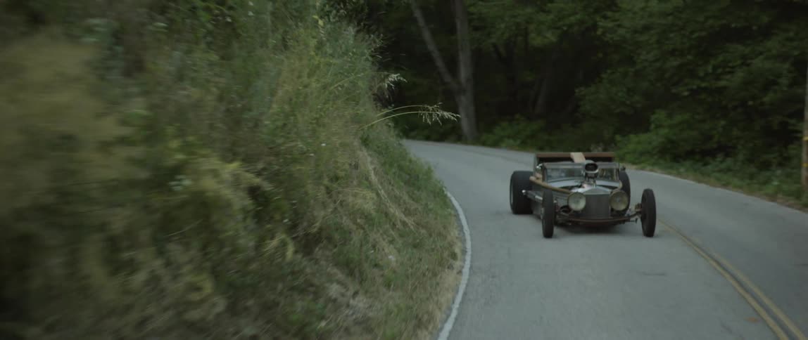 Futuristic roadster cruising through a mountain road