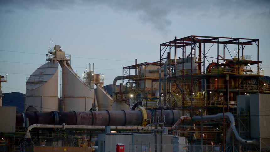 Smoke plumes out of a refinery