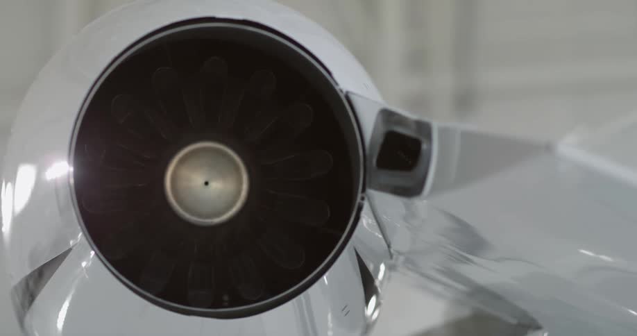 A jet engine is connected to a plane wing