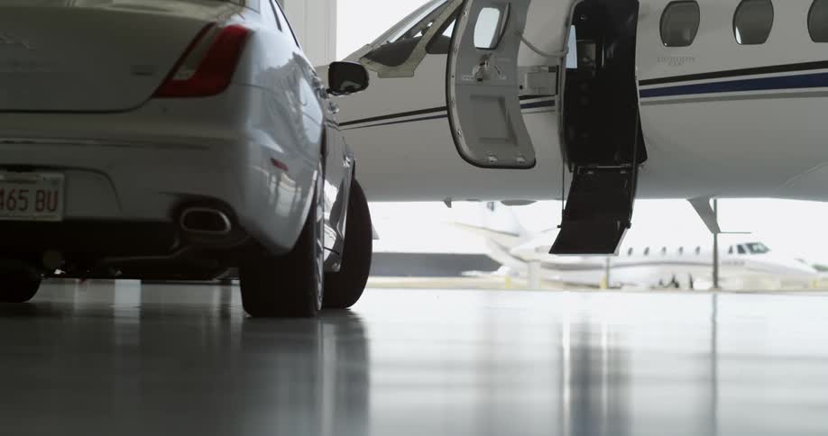 A man and a woman getting into a private jet