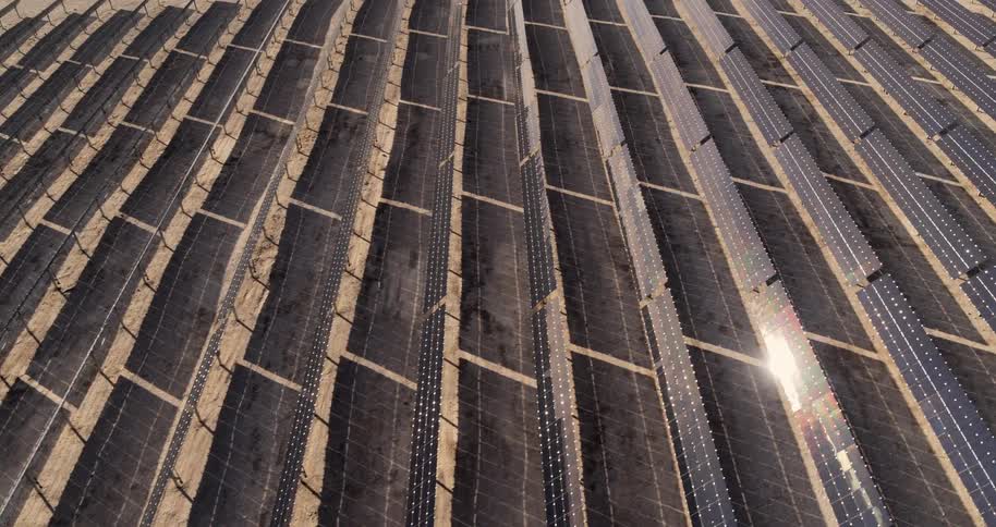 Rows of solar panels reflect sunlight