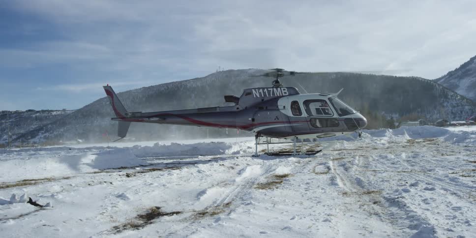 A helicopter is parked in an arctic area