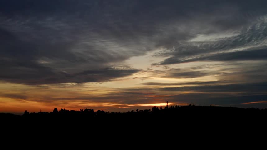 Storm clouds moving across the horizon at sunset in the country