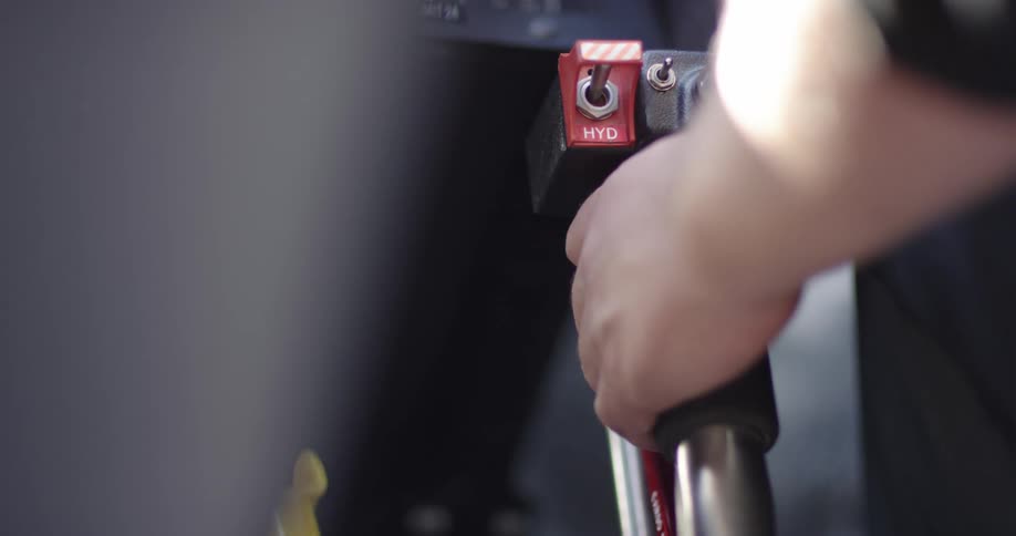 A man holds on to a lever