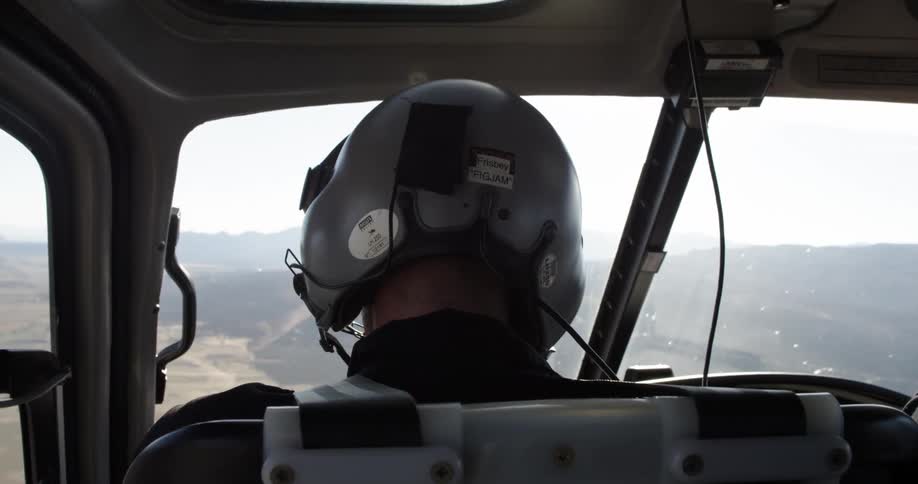 A man is flying a helicopter outdoors