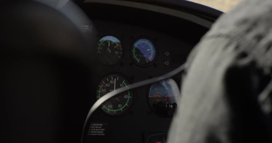 Two people sit in a car with the dashboard showing