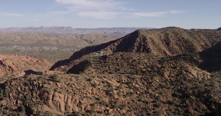 A mountain range covered in brush and trees stretches to the horizon