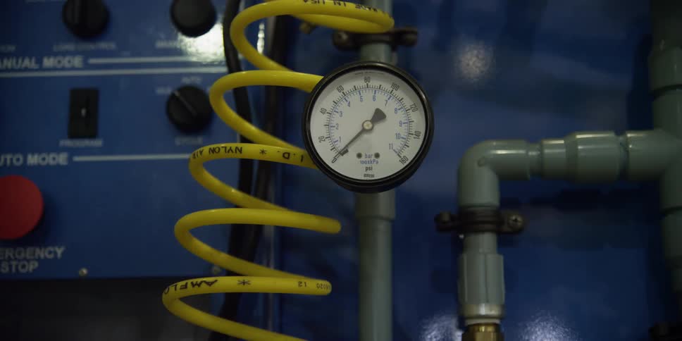 A gauge on equipment inside a factory