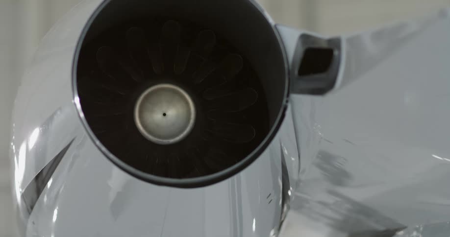 Light shines and reflects off the surface of an airplane jet engine