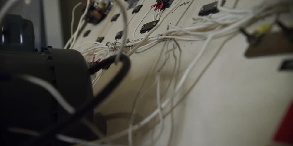 Cables and switches make up an electrical board for a machine