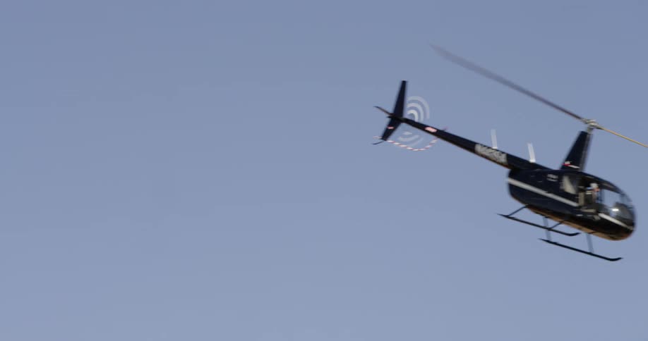 A helicopter flies over a nature area