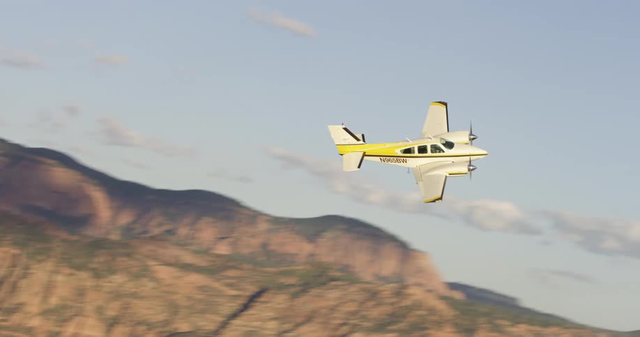 An airplane is flying above the mountains
