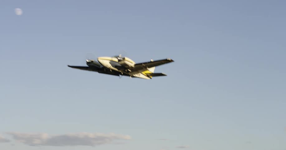 A small plane flying low over a mountainous landscape