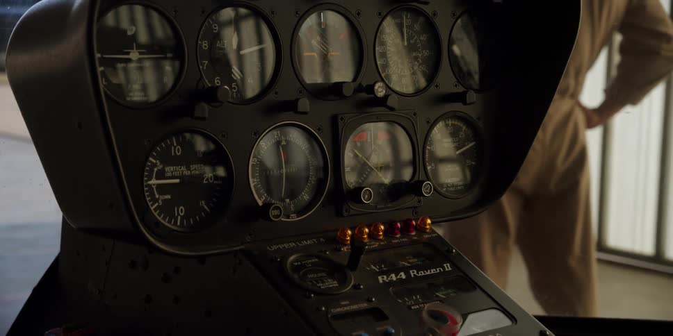 A control panel in a helicopter with a person standing in front of it