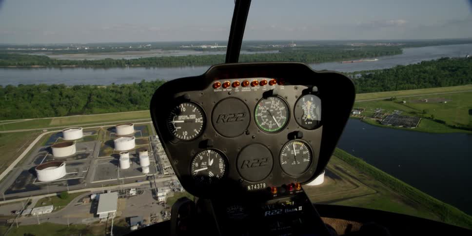 A helicopter with gauges with the sky and rivers in the background