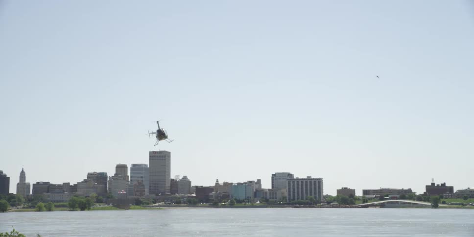 A helicopter is flying above the ocean