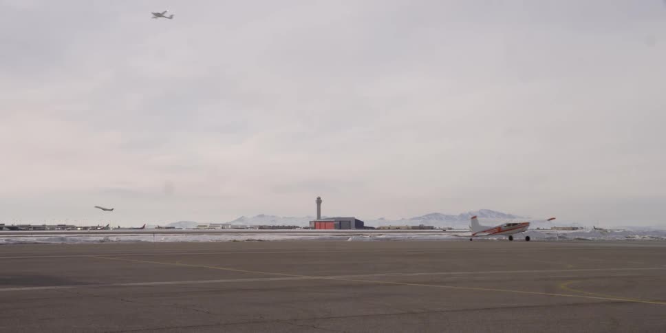 Airplanes fly and take off an airfield at winter