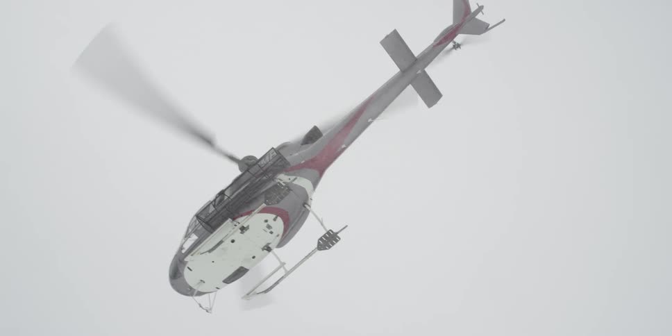 A helicopter flies outdoors in a snow storm