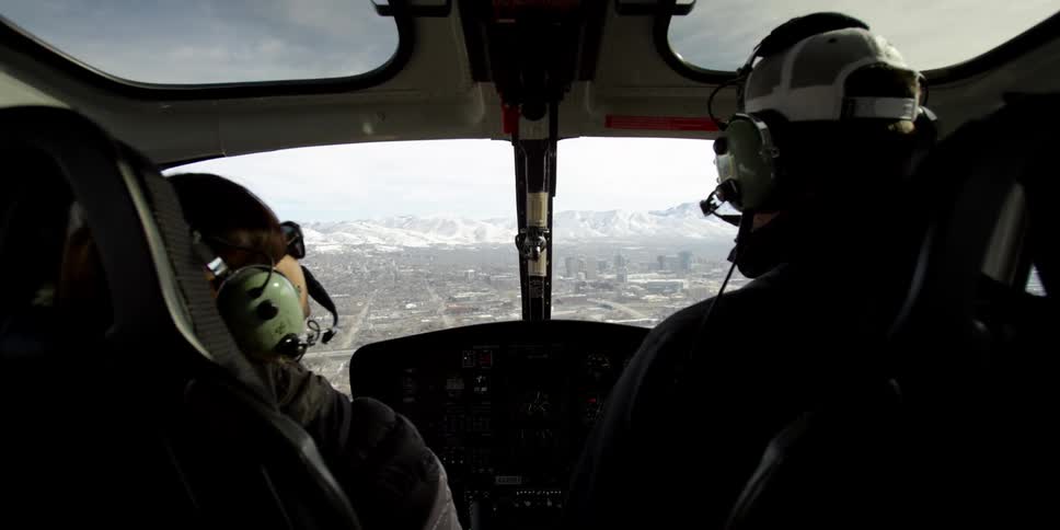 A man and woman are flying in an airplane