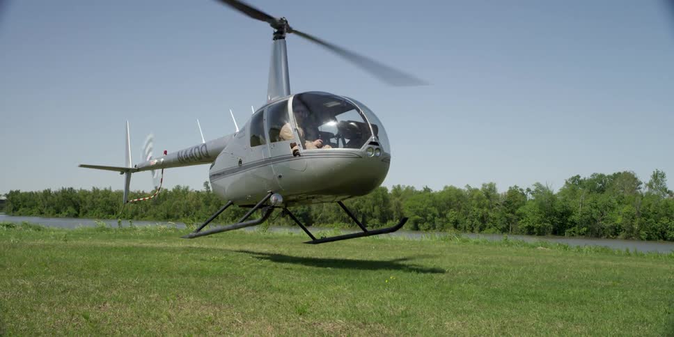A helicopter is parking on a grassland area