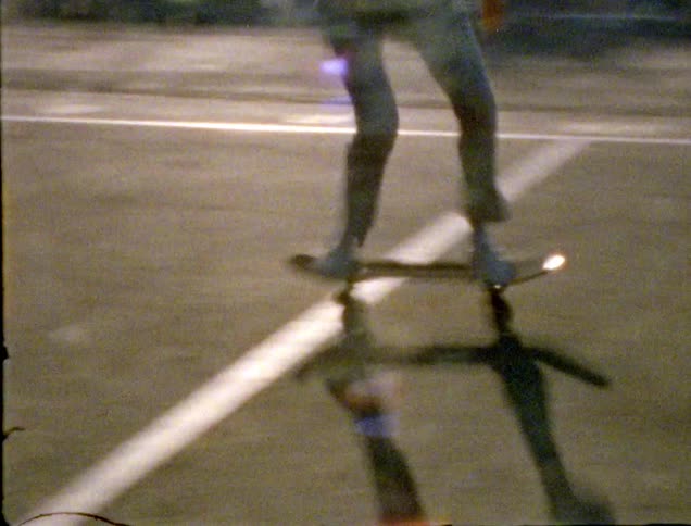 A teenager skateboarding outside