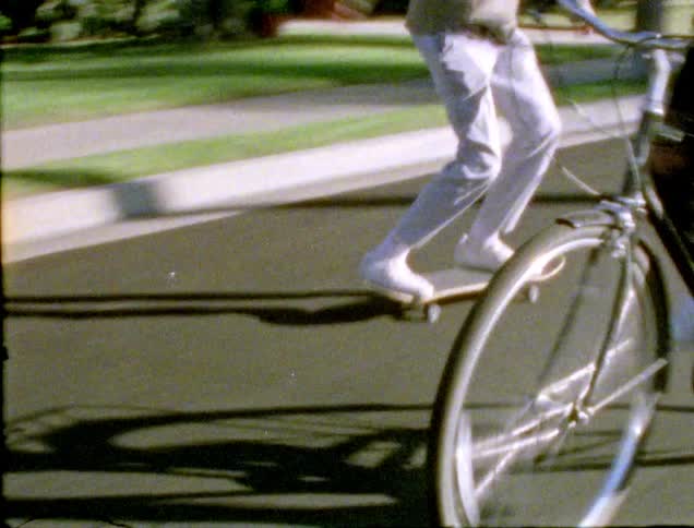 Friends skateboarding and bike riding around the neighborhood