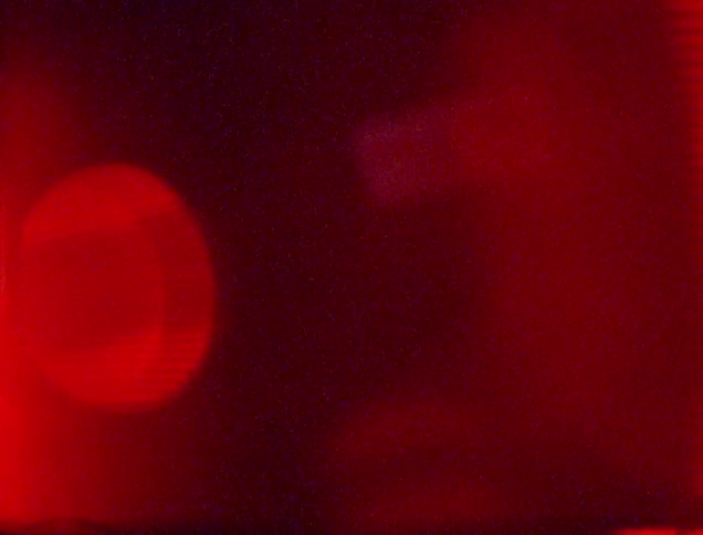 A red light is flashing in the dark