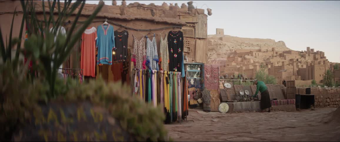 A woman places items on the wall outside