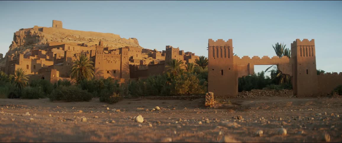 An abandoned town in the middle of the desert with the sky in the background