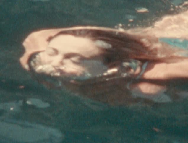Woman swimming and diving in a lake