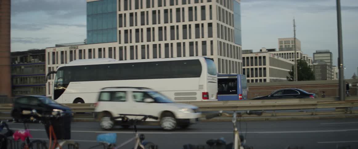 Blue bus and vehicles drive along divided highway