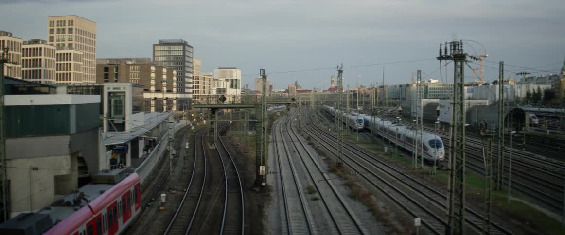 A train rolls through a rail yard near the downtown area of a city